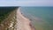 Aerial view flying along Latvian Baltic sea seaside beach coast. People on beach