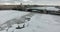 Aerial view. Flying along the river Neva in winter overcast cold weather. Bridge over the river Petersburg. The height of the bird