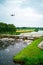 An aerial view with a flying drone in the background above a weir in the river Vecht. Lock keepers house next to the