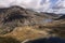 Aerial view of flying drone Epic Autumn Fall landscape image of view along Ogwen vslley in Snowdonia National Park with moody sky