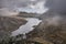 Aerial view of flying drone Epic Autumn Fall landscape image of view along Ogwen vslley in Snowdonia National Park with moody sky