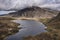 Aerial view of flying drone Epic dramatic Autumn landscape image of Llyn Idwal in Devil`s Kitchen in Snowdonia National Park with