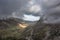 Aerial view of flying drone Epic landscape image in Autumn looking down Nant Fracon valley from Llyn Idwal with moody sky and