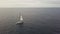Aerial view from flying drone sail yacht in blue sea on cloudy sky landscape
