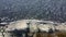 Aerial view, flying over coastline during a storm. Slow motion, Camera moves backwards above rocky shore and sea waves with foam