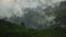 Aerial View. Flying over the high mountains in beautiful misty clouds. rain forest mountain during the rainy season