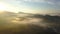 Aerial View, Flying over the mountains and trees with beautiful clouds and sky in sunrise