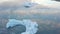 Aerial view flying over stunning icebergs floating in Jokulsarlon lagoon, romantic natural landscape and powerful message of clima