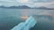 Aerial view flying over stunning icebergs floating in Jokulsarlon lagoon, romantic natural landscape and powerful message of clima