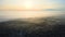 Aerial view of foggy morning over snow covered white forest with frozen trees in cold winter. Dense wild woodland in