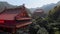 Aerial view footage of buddhist temple complex with mountains