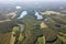 Aerial view of forest, gravel road and many small lakes