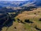 Aerial view, forest roads leading trough pine woods  to a small hungarian village