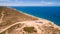 Aerial view of four wheel drive vehicle and caravan parked at The Great Australian Bight on the Edge of the Nullarbor Plain