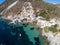 Aerial view of Fourkovouni beach with houses, cliffs and vegetation