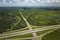 Aerial view of freeway overpass junction with fast moving traffic cars and trucks. Interstate transportation