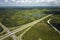 Aerial view of freeway overpass junction with fast moving traffic cars and trucks. Interstate transportation