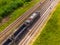 Aerial view of freight train wagons on large railway track field. Concept of modern logistics. Coal delivery