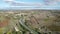 Aerial view of a French town surrounding by colorful farmland in southern France