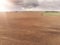 Aerial view, freshly ploughed brown agricultural land, Cloudy sky, sun flare and rays over land, Selective focus