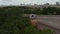 Aerial view of front of diesel locomotive standing of track. Panning view gradually revealing train engine. Highway