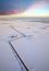 Aerial view of the frosty lake with the oil field