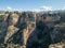 Aerial view at the full Ronda city, iconic New Bridge above the gauge, natural geological phenomenon, erosion cliffs, touristic