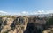 Aerial view at the full Ronda city, iconic New Bridge above the gauge, natural geological phenomenon, erosion cliffs, touristic