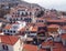 Aerial view of funchal in madeira showing red tiled roofs of old white buildings with the coast in the distance