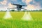 Aerial view futuristic agricultural drone,spraying chemicals or organic fertilizers into water droplets in agricultural areas