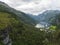 Aerial view on Geirangerfjord fjord with Geiranger tourist village and cruise ship, UNESCO World Heritage. View from