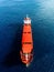 Aerial view of general cargo ship in blue sea. View from above of red empty container ship in the sea