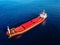 Aerial view of general cargo ship in blue sea. View from above of red empty container ship in the sea