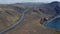 Aerial view gently rotating over Ring Road with cars driving peacefully across volcanic landscape in Iceland. Scenery