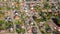 Aerial view of a German suburb with two streets and many small houses for families, photographed by a gyrocopter.
