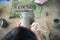 Aerial view of girl hand holding the clay pottery and wooden stick for drawing some text and art work on blank surface. Workshop