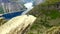 Aerial view. Girl is sitting on the edge of a high cliff. Extreme tourism. Norway