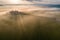 Aerial view of the goggy landscape at farmhouse Poggio Covili at sunrise in Val d\\\'Orcia, Tuscany, Italy