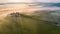 Aerial view of the goggy landscape at farmhouse Poggio Covili at sunrise in Val d\\\'Orcia, Tuscany, Italy