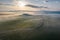 Aerial view of the goggy landscape at farmhouse Poggio Covili at sunrise in Val d\\\'Orcia, Tuscany, Italy