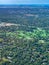 Aerial view of a golf course in a  densely forested urban development