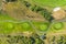 Aerial view of golf course. Drone or helicopter view of green field sand bunker