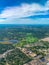 Aerial view of golf courses in a densely forested urban development