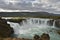 Aerial view of Gooafoss Waterfall under blue cloudy sky in Iceland