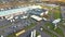 Aerial view of goods warehouse. Logistics center in industrial city zone from above. Aerial view of trucks loading at logistic