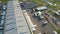 Aerial view of goods warehouse. Logistics center in industrial city zone from above. Aerial view of trucks loading at logistic