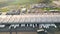 Aerial view of goods warehouse. Logistics center in industrial city zone from above. Aerial view of trucks loading at logistic