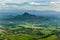 Aerial view of green cultivated fields in front of mountains on island of Roatan, Honduras