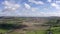 Aerial view of green farmland in Ireland. Irish rural landscape, panorama, little village, empty road, hills in the