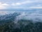 Aerial view green forest in sea cloud morning